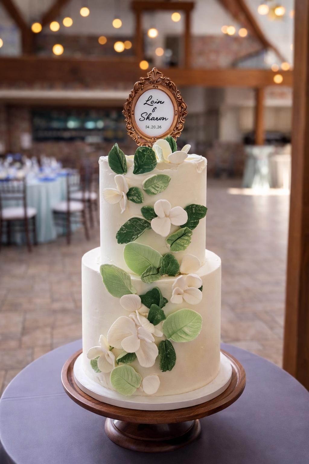 Two-tiered cake with sugar leaves and flowers