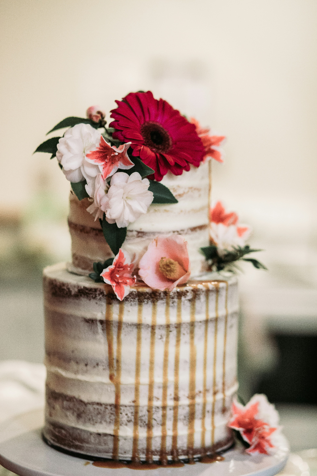 Semi-naked cake with caramel drip and red gerbera