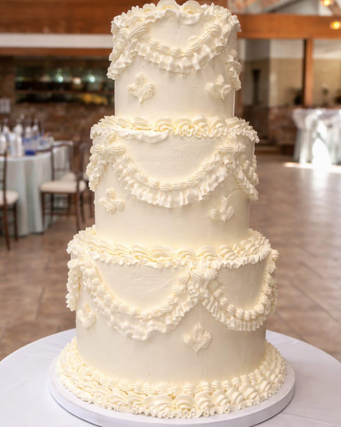 Four-tiered vintage piped cake with swag details