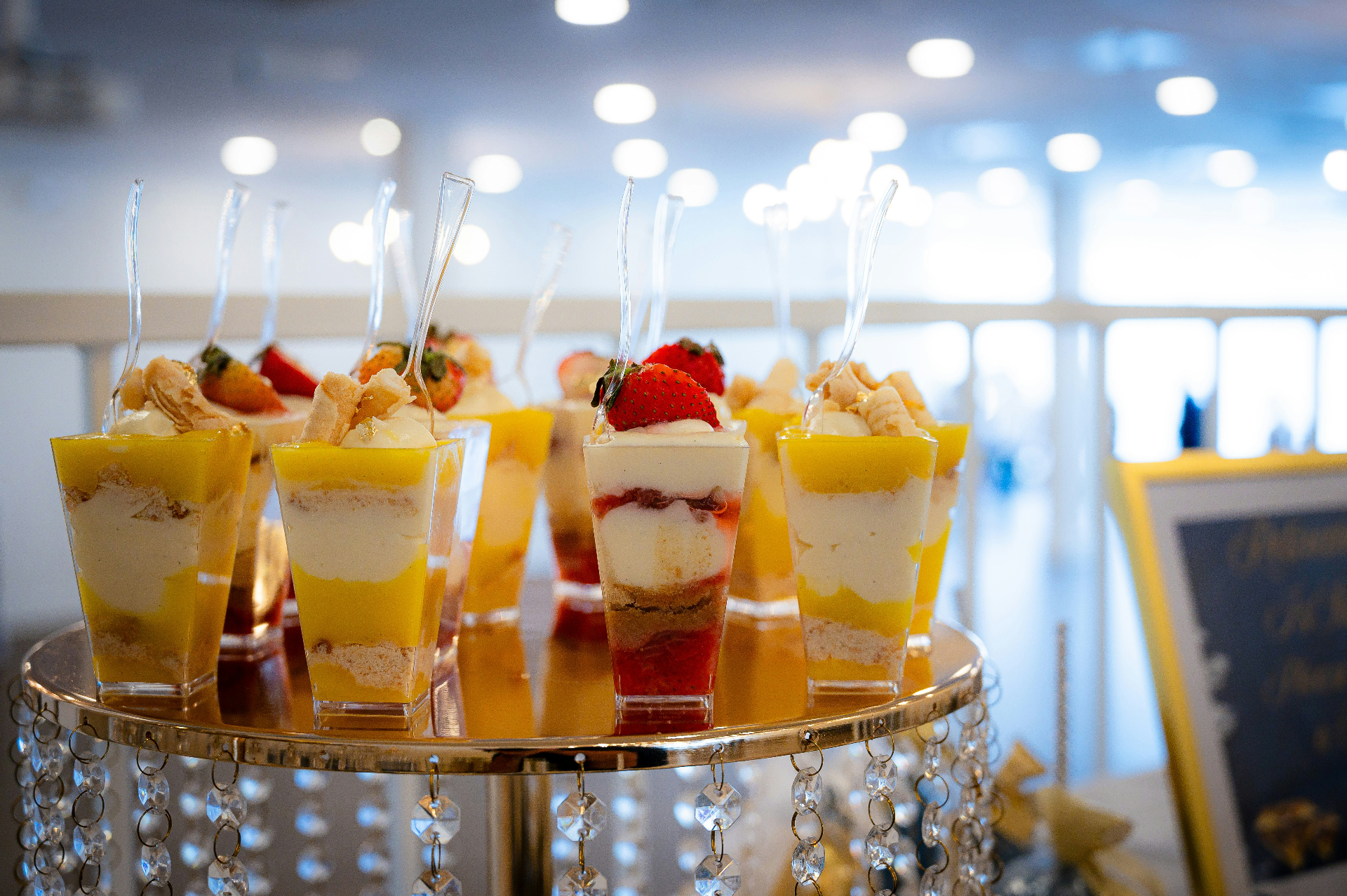 Mango and strawberry dessert shooters on crystal stand