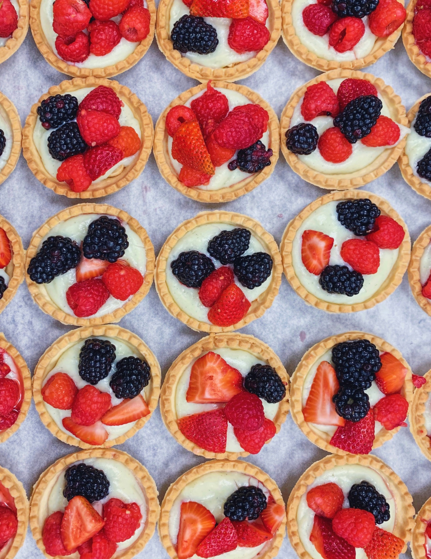 Mini berry tartlets with fresh strawberries and blackberries